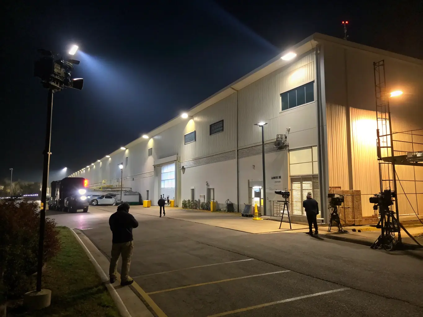 A commercial building exterior at night, highlighting Zentryva's security monitoring services with visible CCTV cameras.